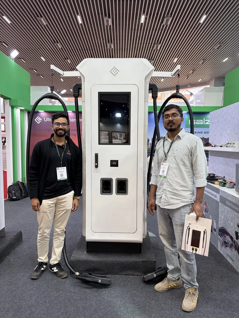 UltraFast EV charger with two people at an exhibition, showing the white enclosure, touchscreen and charging cables.